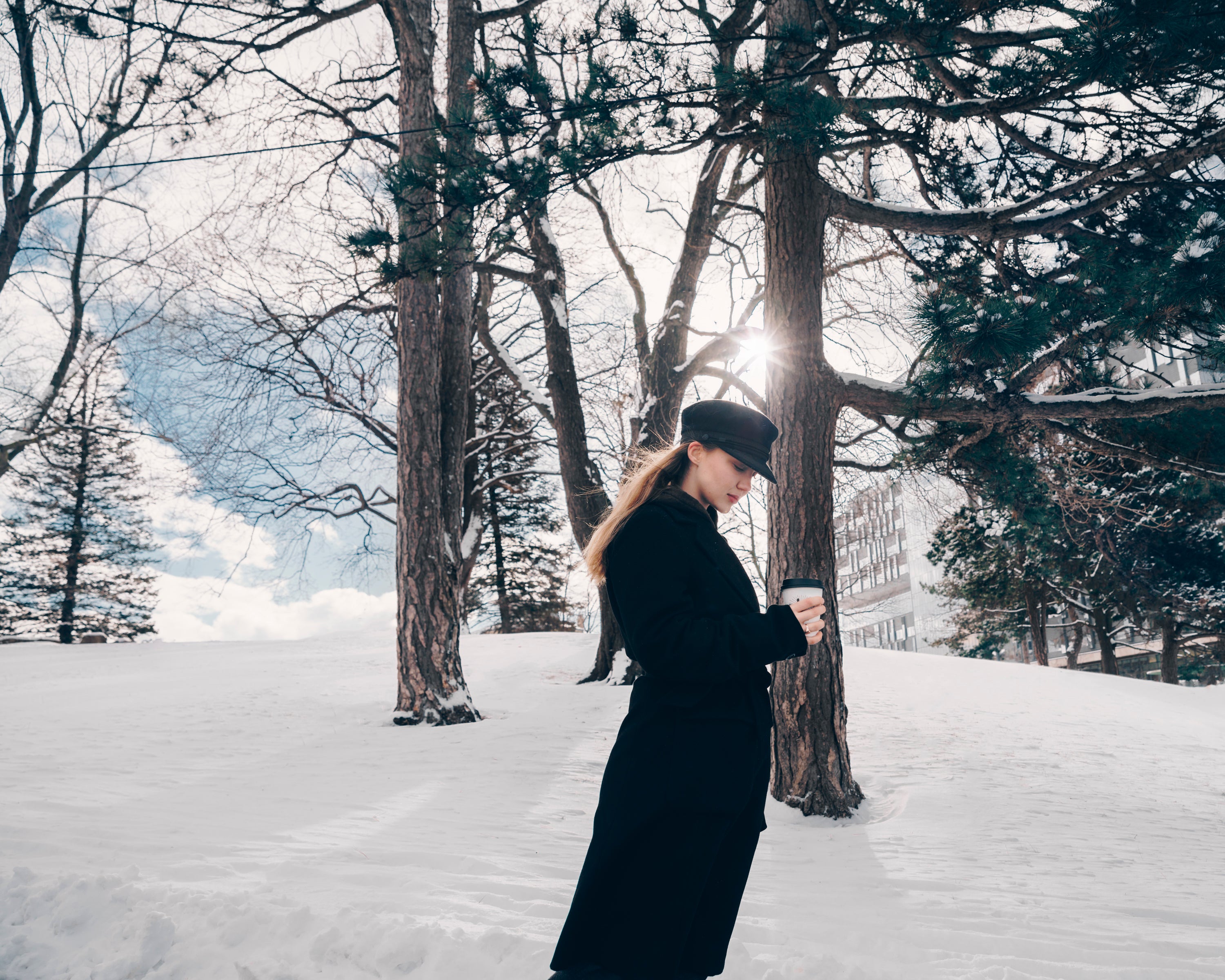 woman-in-black-trench-in-winter-woods.jpg